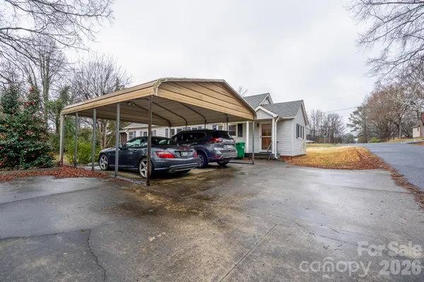 a view of a house with a yard and pathway