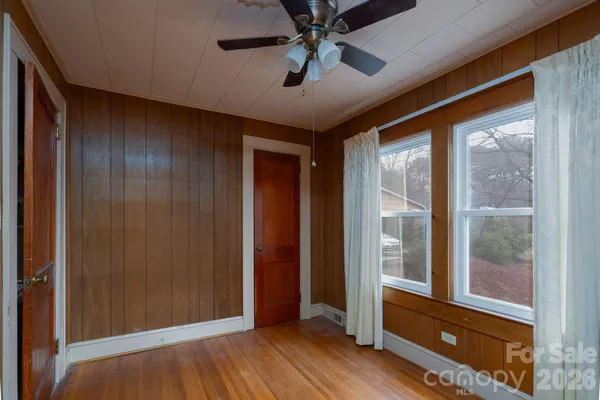 a view of room with window and wooden floor