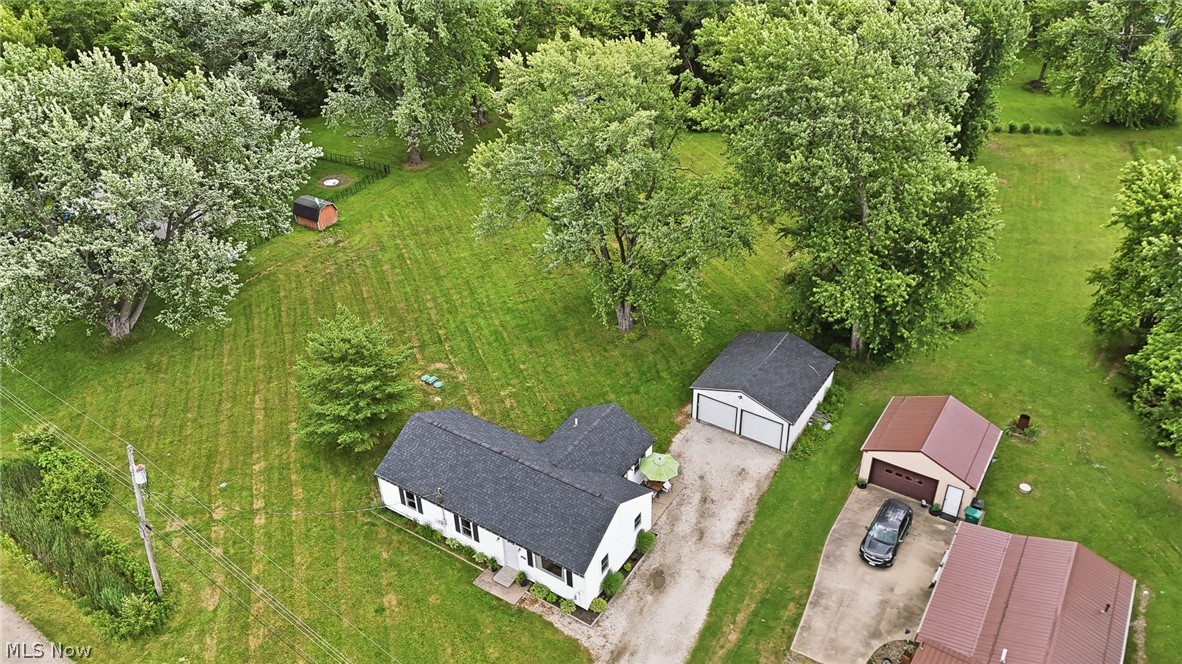 3471 State Rte 5 Newton Falls, OH 44444 - Photo 31 of 31 Aerial perspective showcasing a single-story home with a dark shingle roof, expansive green lawn, and mature trees