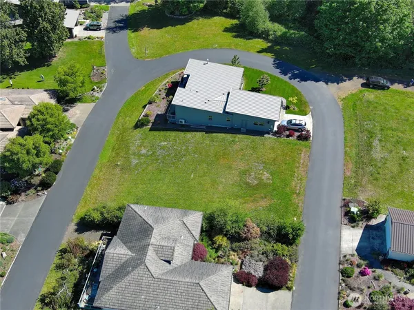 an aerial view of a house with a garden and swimming pool