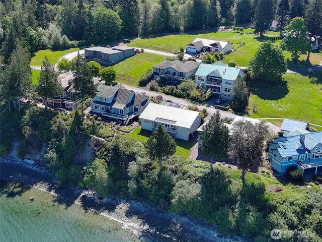 an aerial view of a house with a swimming pool yard and outdoor seating