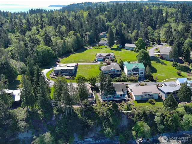 an aerial view of a house with swimming pool outdoor seating and yard