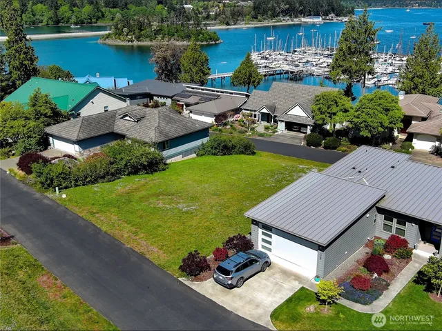 an aerial view of a house with garden space and lake view