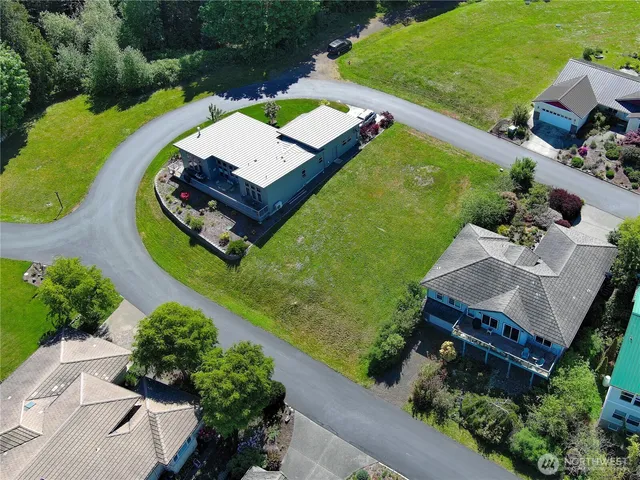 an aerial view of a house with a garden and swimming pool