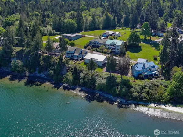 an aerial view of a house with a garden and swimming pool