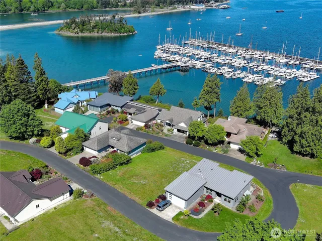an aerial view of a house with a garden and lake view
