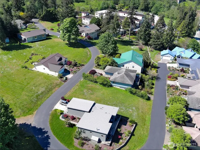 an aerial view of a house with garden space and lake view