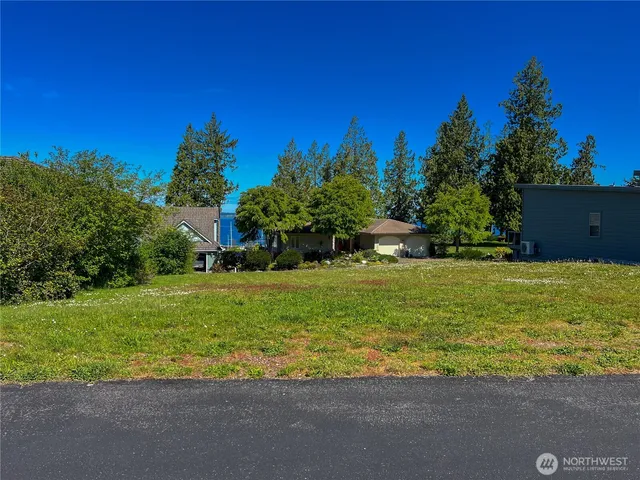 a view of a house with a yard and a garage