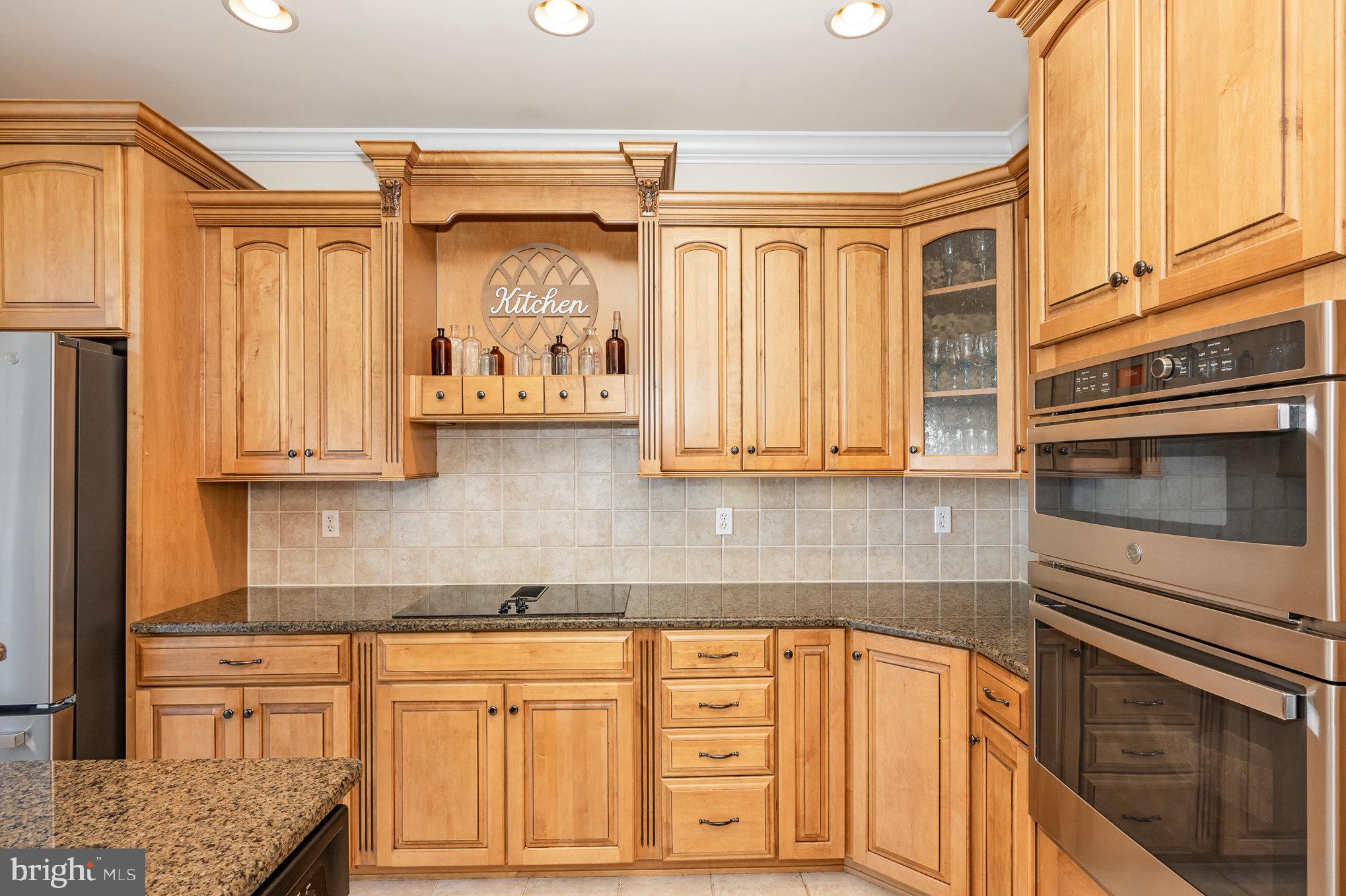 8291 Clearfield Road Denton, MD 21629 - Photo 12 of 40 a kitchen with stainless steel appliances granite countertop a stove a sink and a microwave