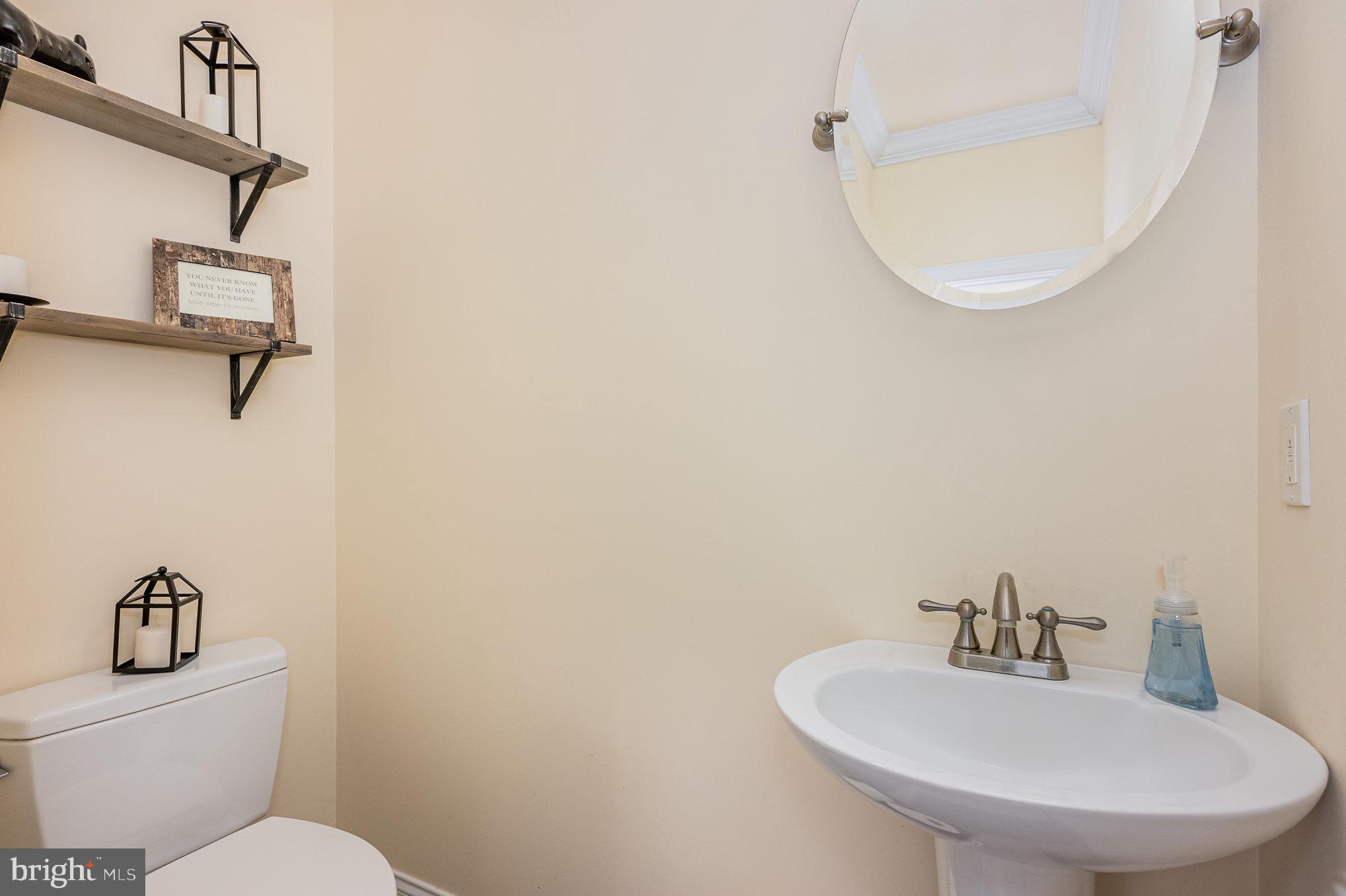 8291 Clearfield Road Denton, MD 21629 - Photo 17 of 40 a bathroom with a sink a toilet and a mirror