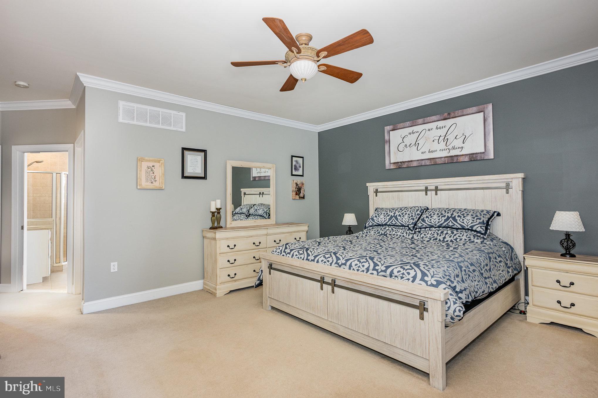 8291 Clearfield Road Denton, MD 21629 - Photo 19 of 40 a bedroom with a bed and painting on the wall
