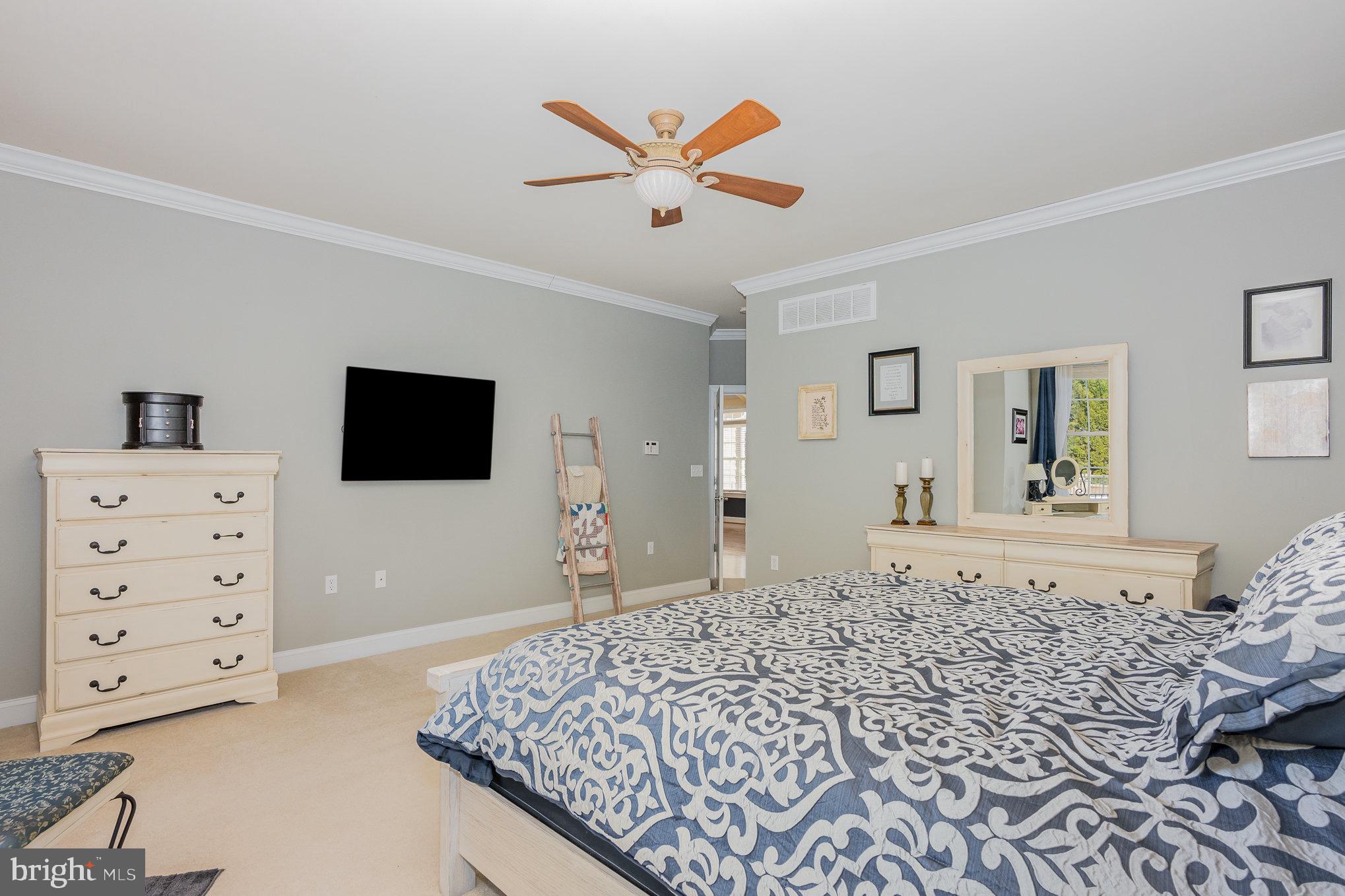 8291 Clearfield Road Denton, MD 21629 - Photo 20 of 40 a bedroom with a bed and a flat screen tv