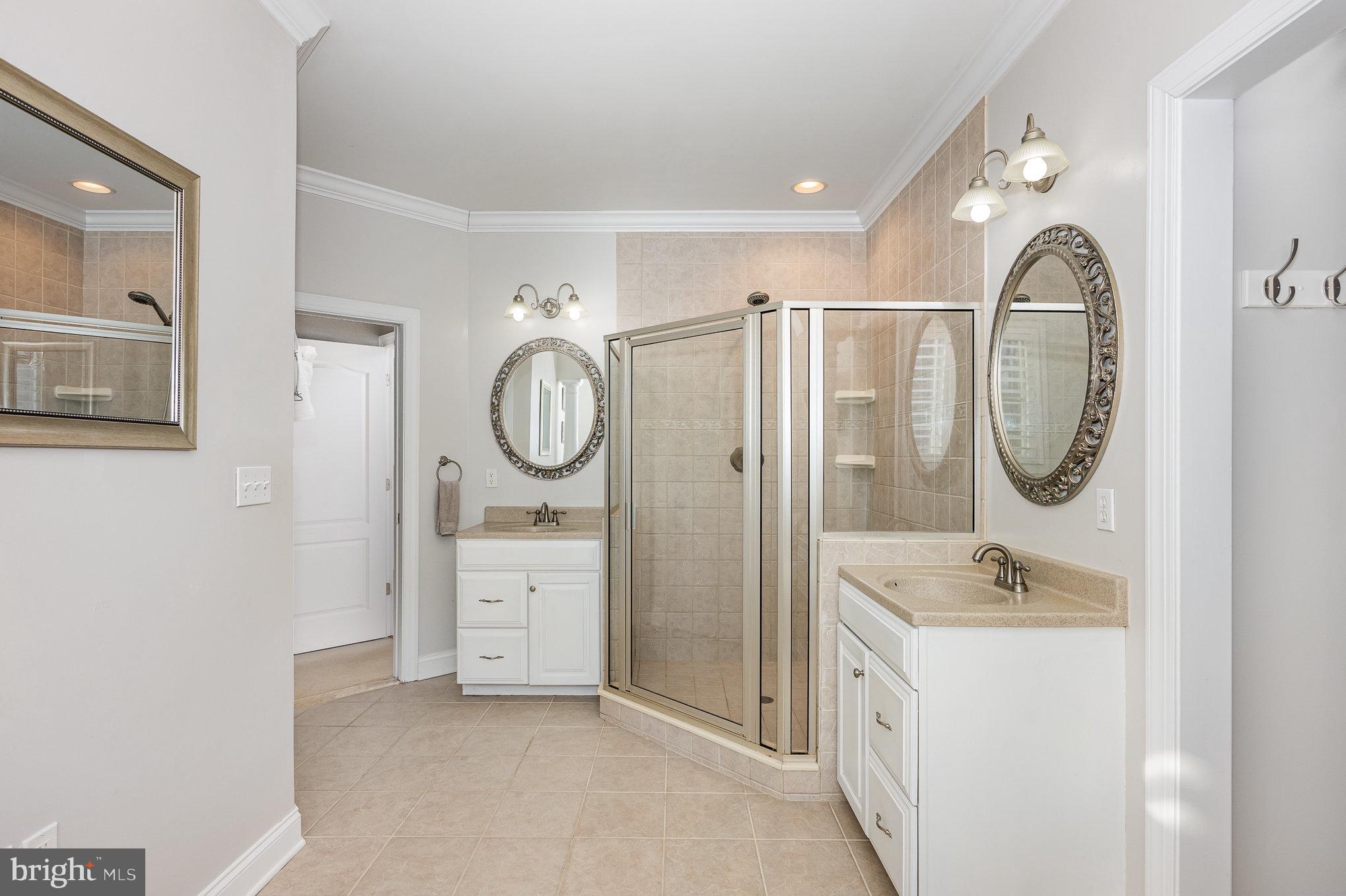8291 Clearfield Road Denton, MD 21629 - Photo 23 of 40 a spacious bathroom with a double vanity sink and a mirror