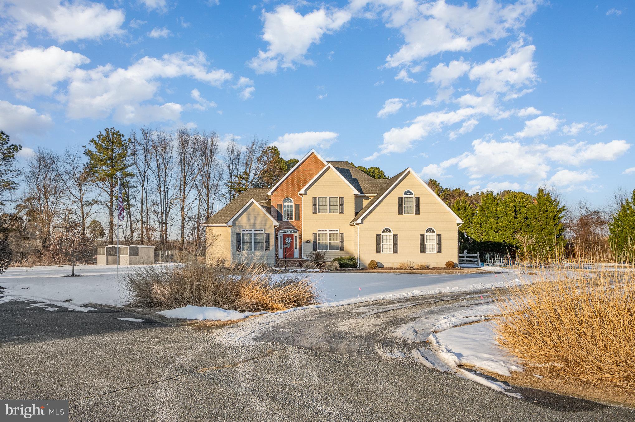 8291 Clearfield Road Denton, MD 21629 - Photo 4 of 40 a front view of a house with a yard and garage