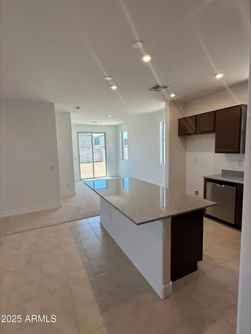 a view of kitchen with stainless steel appliances a refrigerator and a stove top oven