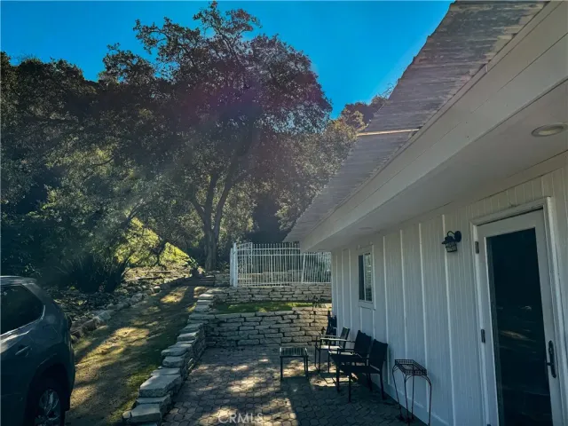 a view of yard and deck with large trees