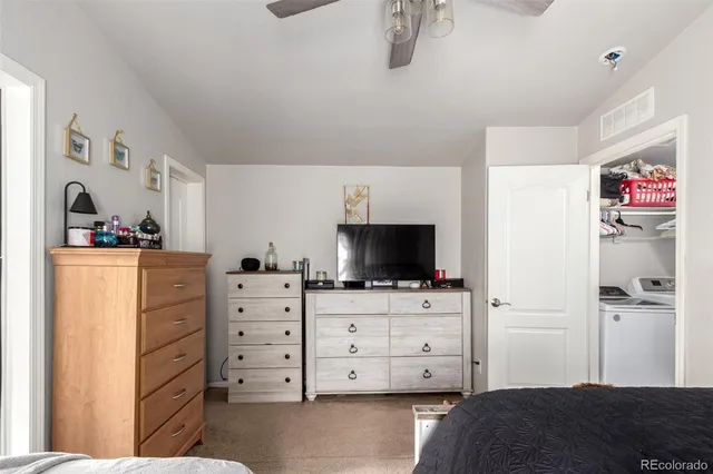 a bedroom with a bed and flat screen tv