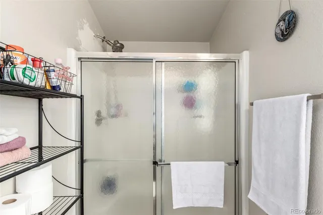 a bathroom with a shower and a sink