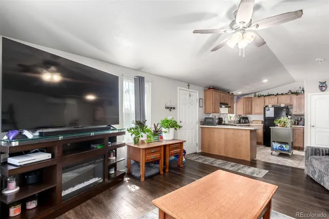 a living room with furniture and kitchen view