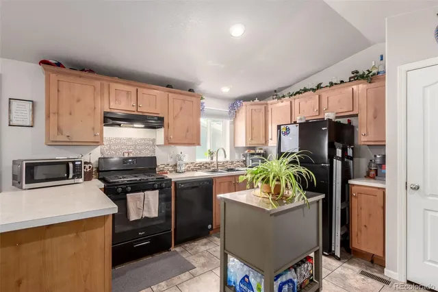 a kitchen with refrigerator a stove and a refrigerator