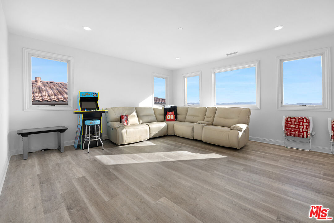 20234 Jubilee Way Porter Ranch, CA 91326 - Photo 25 of 30 a living room with furniture and a wooden floor