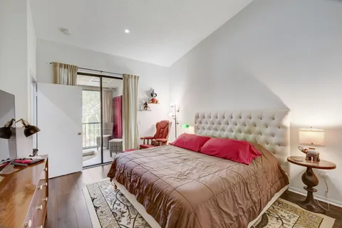 a bedroom with a large bed and a window