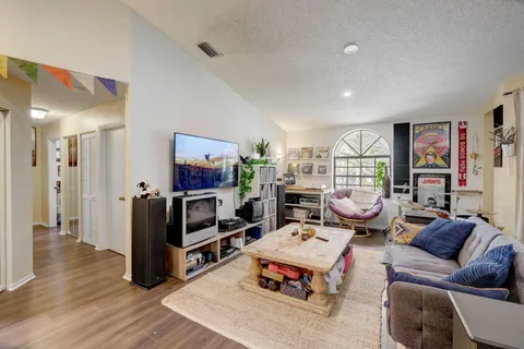 a living room with furniture and a flat screen tv