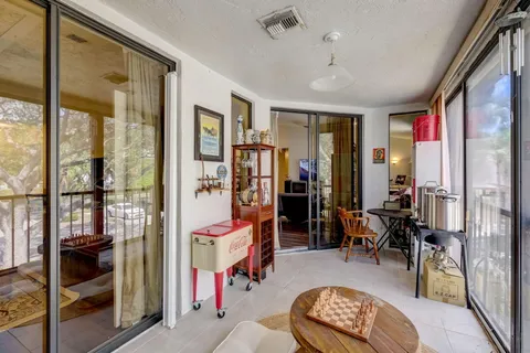a dining room with furniture water view and large windows