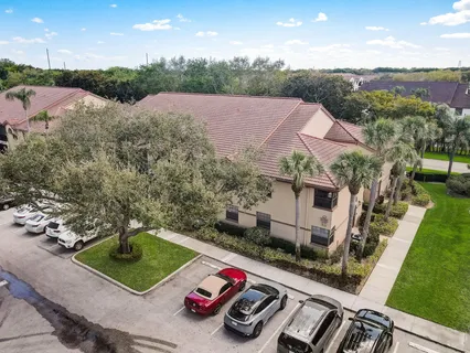 an aerial view of a house with backyard space and lake view