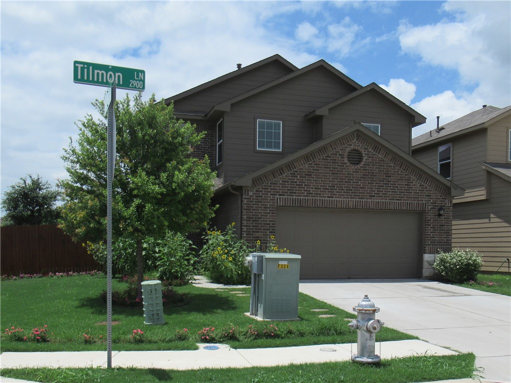 2900 Tilmon Ln. Austin, TX 78725 - Photo 1 of 1 a front view of a house with garden