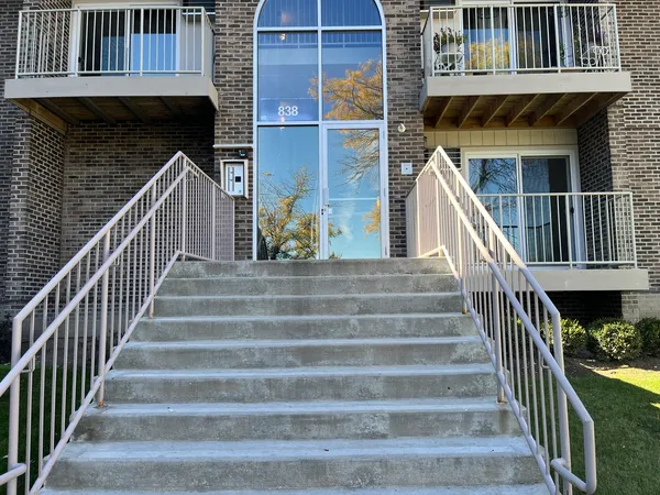 a view of entryway with wooden floor and a front door