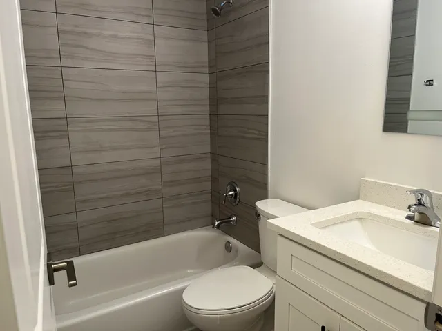 a bathroom with a toilet a sink and bathtub