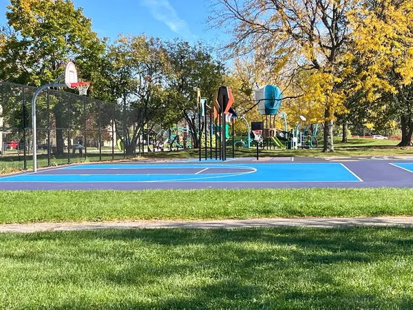 a front view of a building and trees