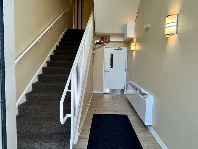 a view of entryway and hall with wooden floor