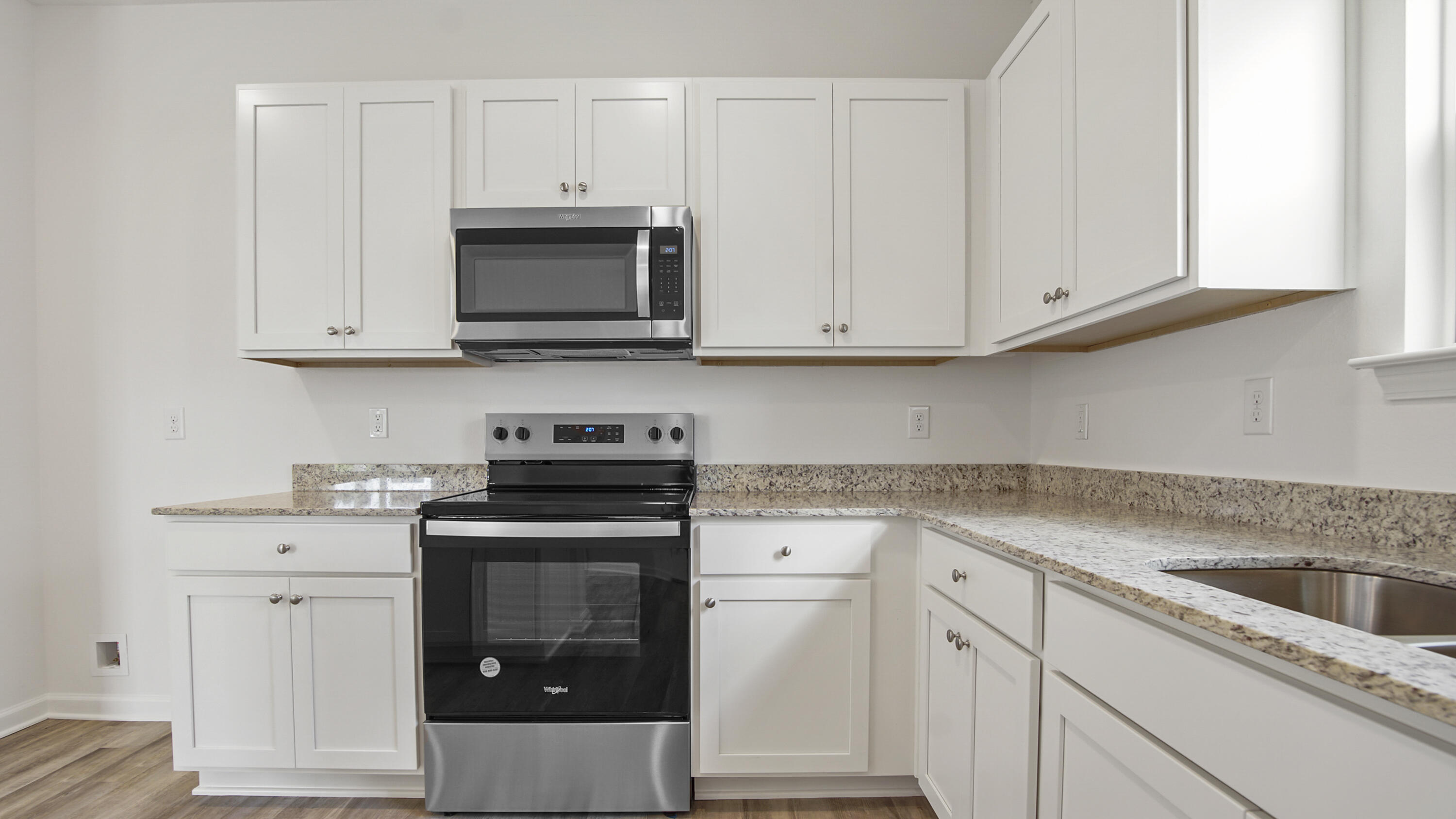 206 Huckleberry Street Freeport, FL 32439 - Photo 14 of 36 a kitchen with granite countertop white cabinets and stainless steel appliances