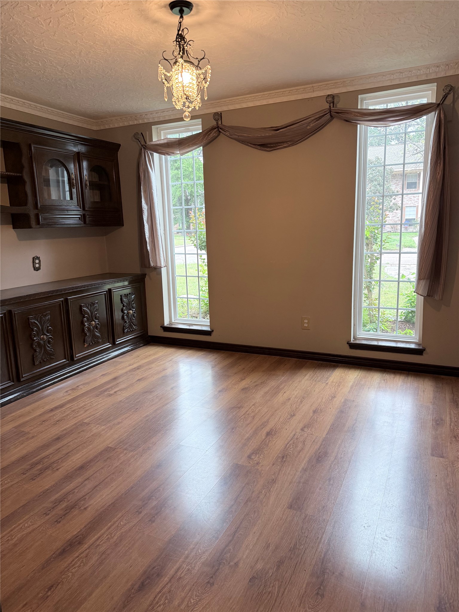 3802 Midforest Drive Houston, TX 77068 - Photo 5 of 31 a view of a livingroom with wooden floor a ceiling fan and windows