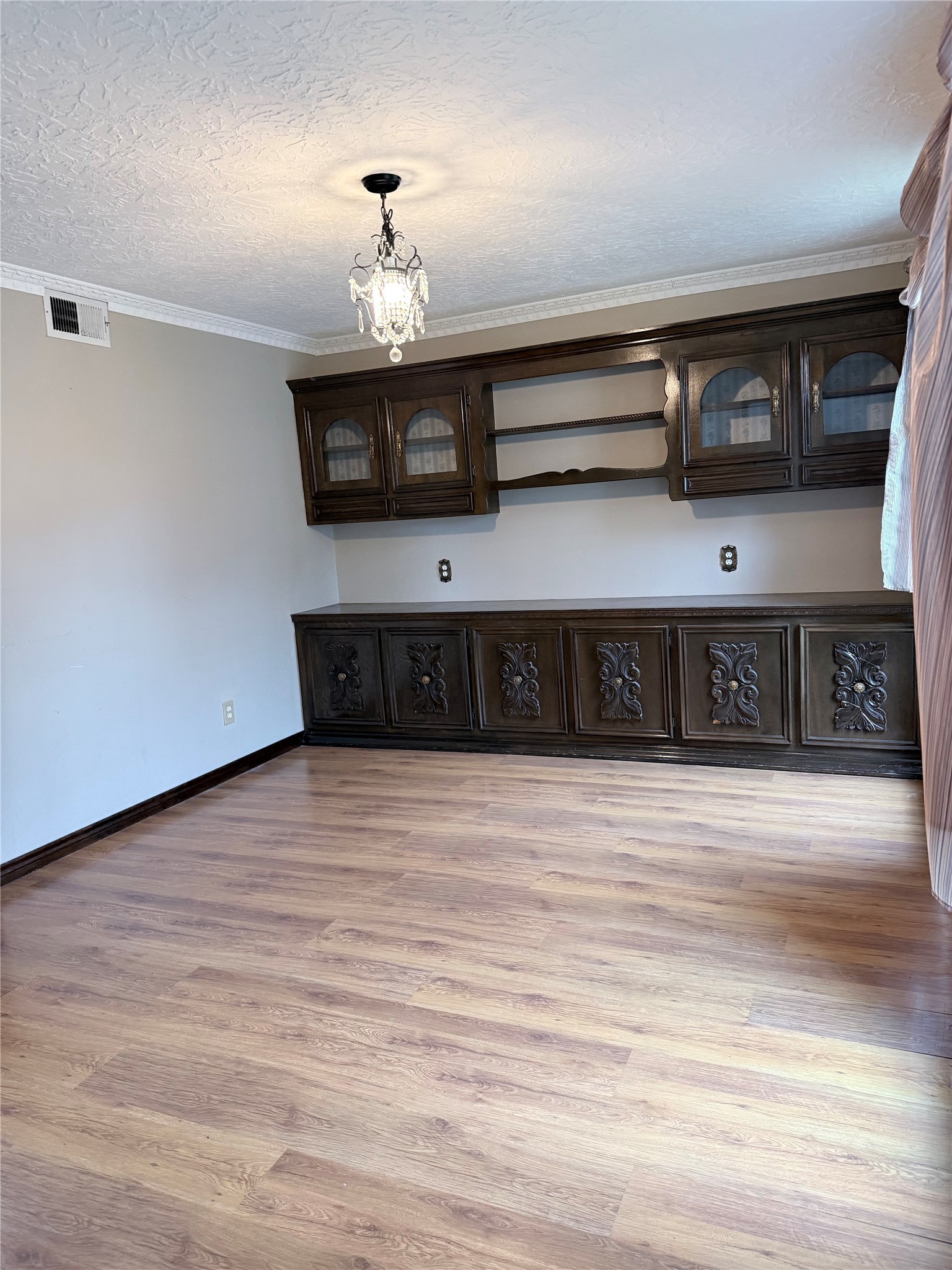 3802 Midforest Drive Houston, TX 77068 - Photo 6 of 31 a view of a living room with stainless steel appliances wooden floor and chandelier