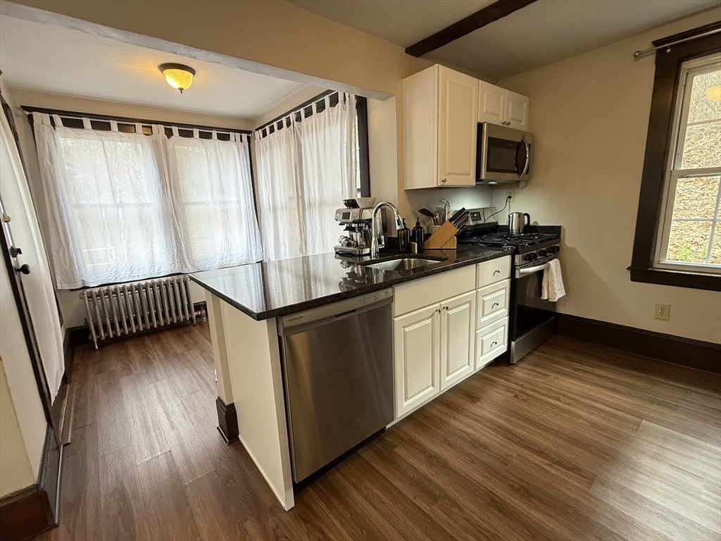 27 Breakneck Hill Road, Unit 27 Southborough, MA 01772 - Photo 13 of 25 a kitchen with stainless steel appliances granite countertop a stove a sink and a refrigerator