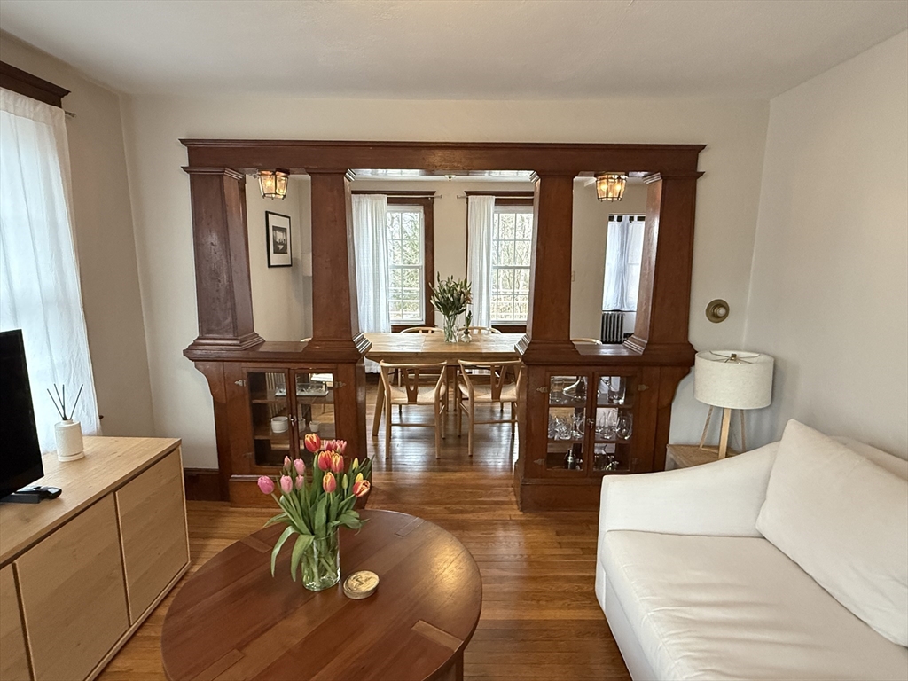27 Breakneck Hill Road, Unit 27 Southborough, MA 01772 - Photo 3 of 25 a living room with furniture a chandelier and wooden floor