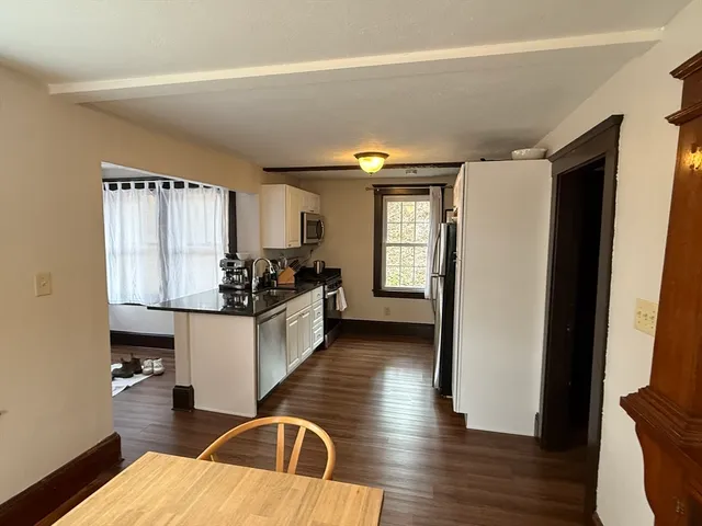 a kitchen with sink refrigerator and window