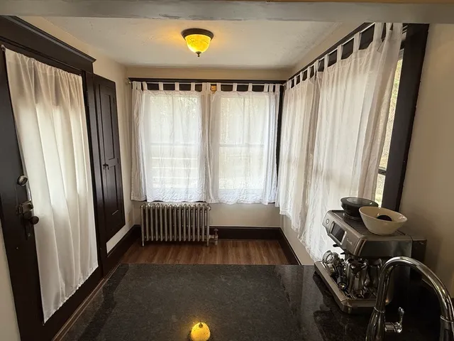 a view of walk in closet with window and glass door