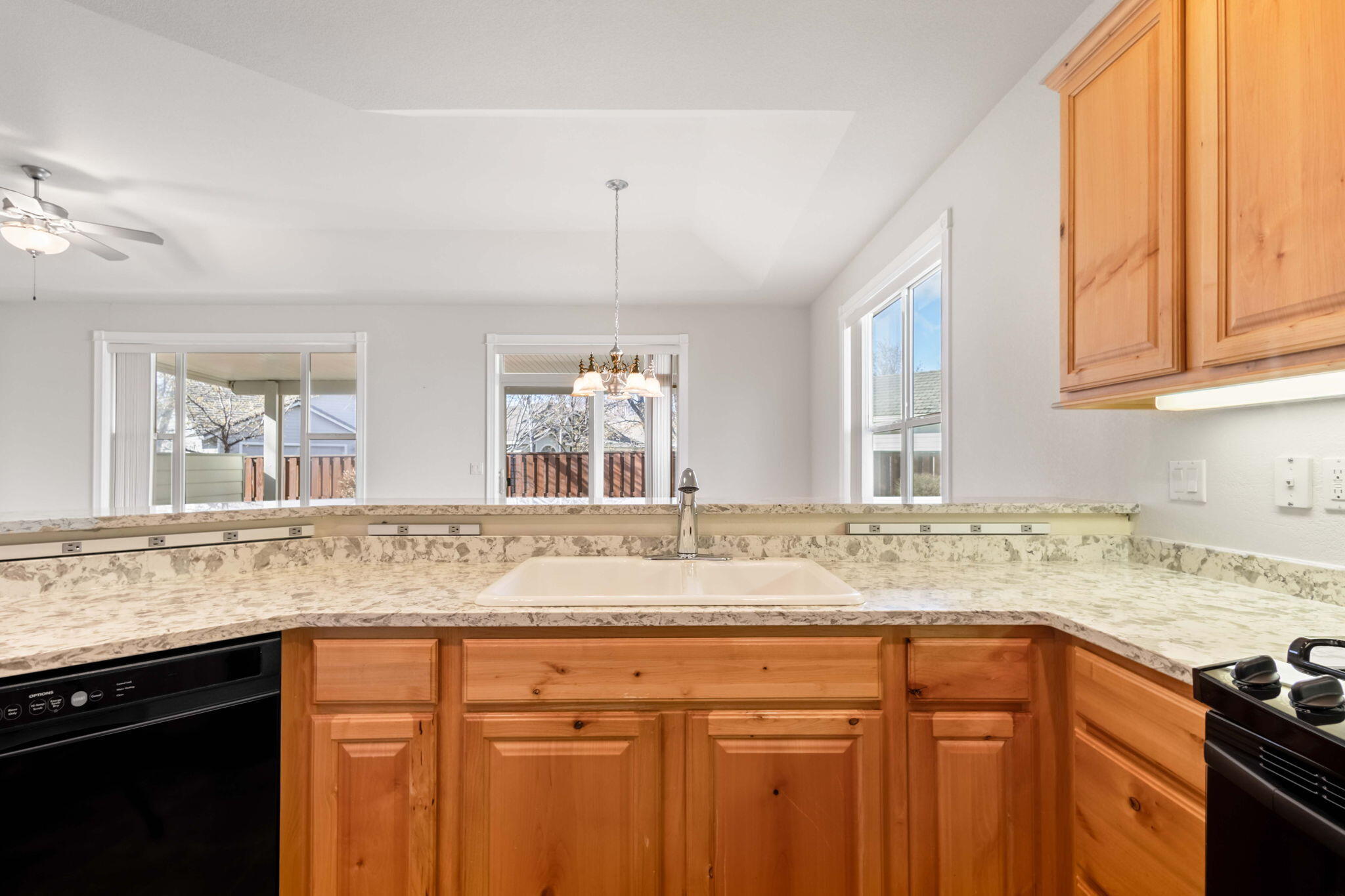 1726 Northwest Cliffside Way Redmond, OR 97756 - Photo 12 of 36 a kitchen with granite countertop stainless steel appliances a sink stove and cabinets