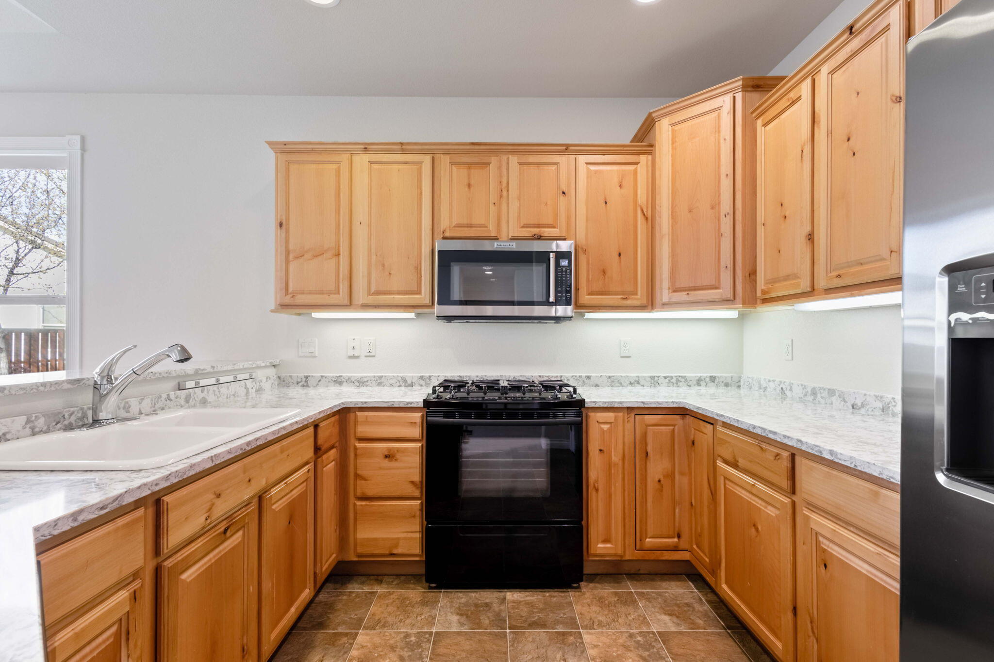 1726 Northwest Cliffside Way Redmond, OR 97756 - Photo 13 of 36 a kitchen with stainless steel appliances granite countertop a stove sink and cabinets