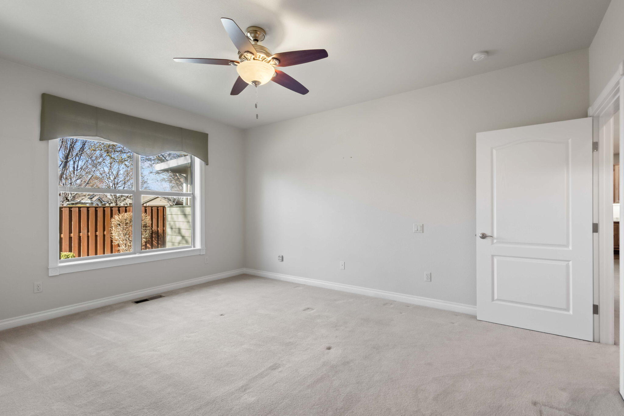1726 Northwest Cliffside Way Redmond, OR 97756 - Photo 19 of 36 an empty room with a window and a ceiling fan