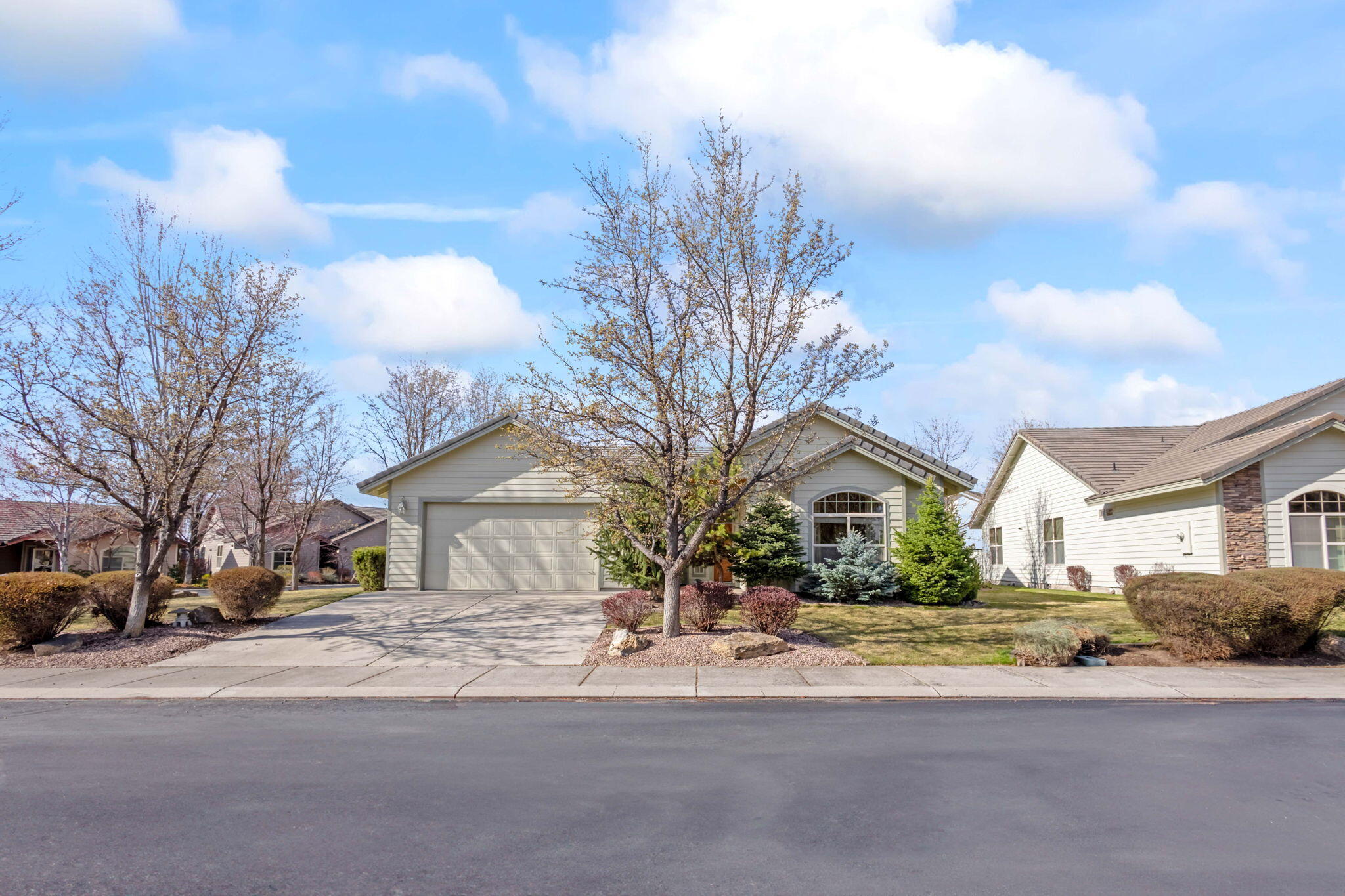 1726 Northwest Cliffside Way Redmond, OR 97756 - Photo 2 of 36 a front view of a house with a yard and garage