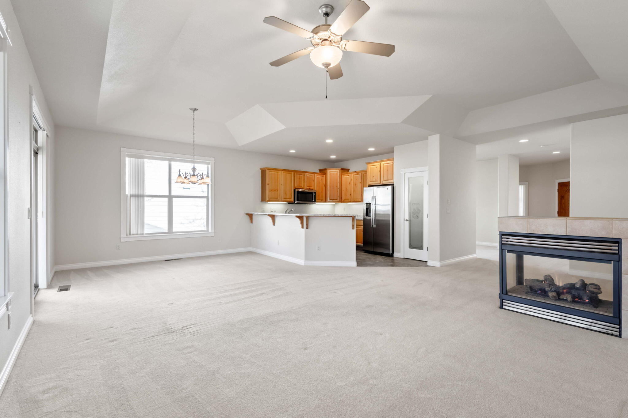 1726 Northwest Cliffside Way Redmond, OR 97756 - Photo 10 of 36 a view of a kitchen with a sink a refrigerator and a fireplace