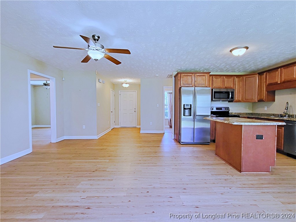 235 Chestnut Drive Raeford, NC 28376 - Photo 12 of 50 a view of kitchen with stainless steel appliances wooden floor and chair