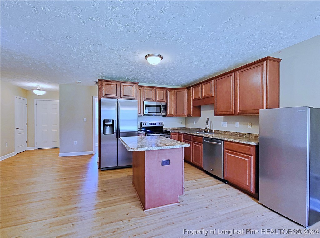 235 Chestnut Drive Raeford, NC 28376 - Photo 17 of 50 a kitchen with stainless steel appliances granite countertop a stove refrigerator sink and cabinets
