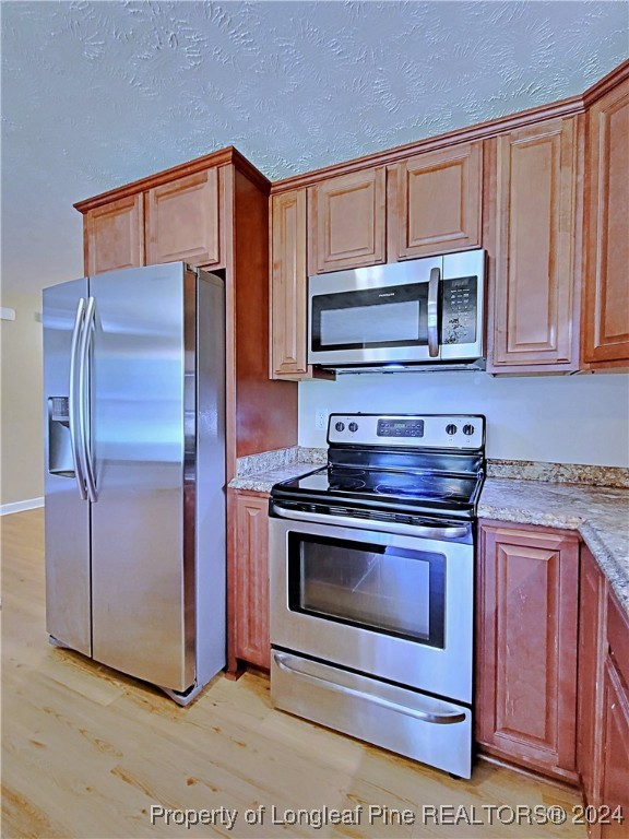 235 Chestnut Drive Raeford, NC 28376 - Photo 20 of 50 a kitchen with granite countertop a stove microwave and refrigerator