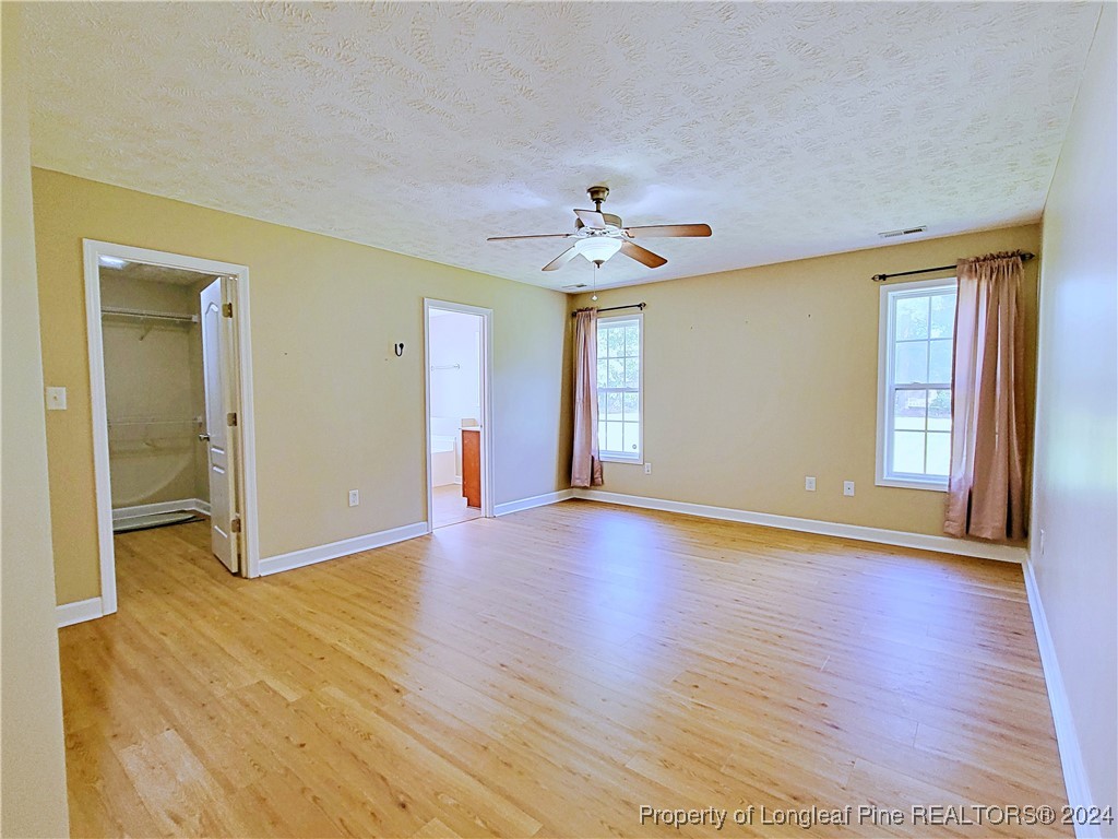235 Chestnut Drive Raeford, NC 28376 - Photo 23 of 50 a view of an empty room with window and wooden floor